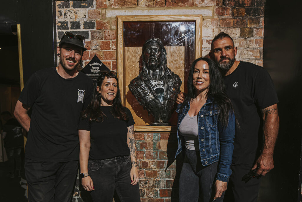 Adam Wood and Amy Lawson, Promotions Manager and Programmer of Rock City respectively, stand beside Vicky and Alan Hungerford on the unveiling of the Lemmy bust